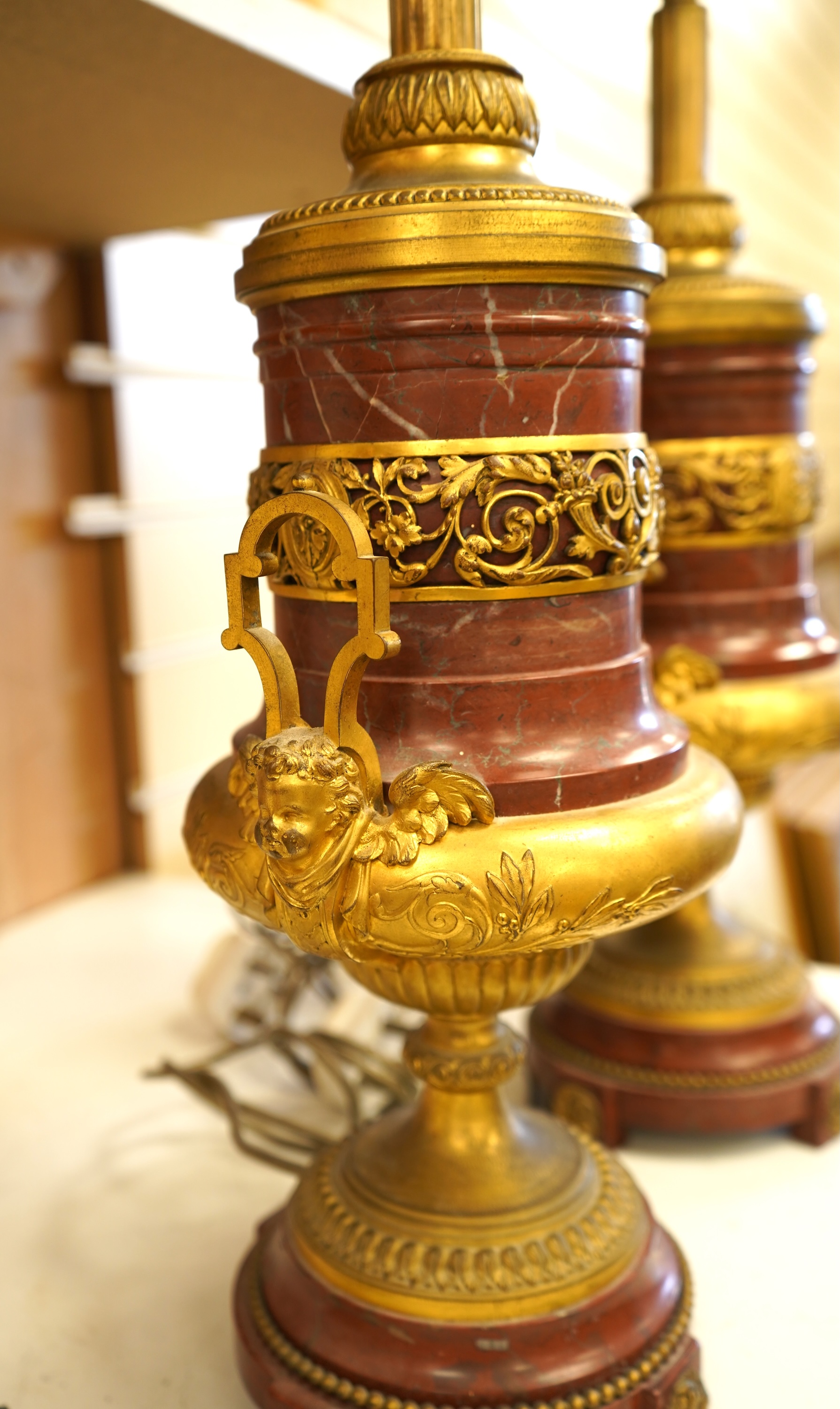 A pair of Empire style gilt metal and rouge marble table lamps, 50cm